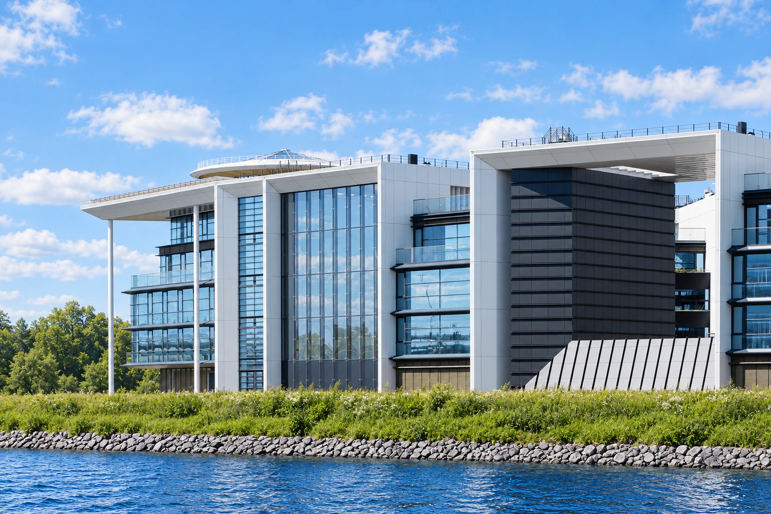 Waterfront view of the yacht club and villas with glazed atrium and open courtyard, natural green planting and grey stone shoreline
